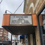 Picture of the theatre marquee for A Christmas Carol, showing Most of Us Buckle Up as a sponsor of the December 2021 performance.