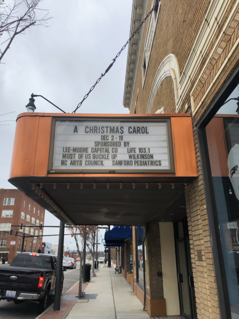 Picture of the theatre marquee for A Christmas Carol, showing Most of Us Buckle Up as a sponsor of the December 2021 performance.