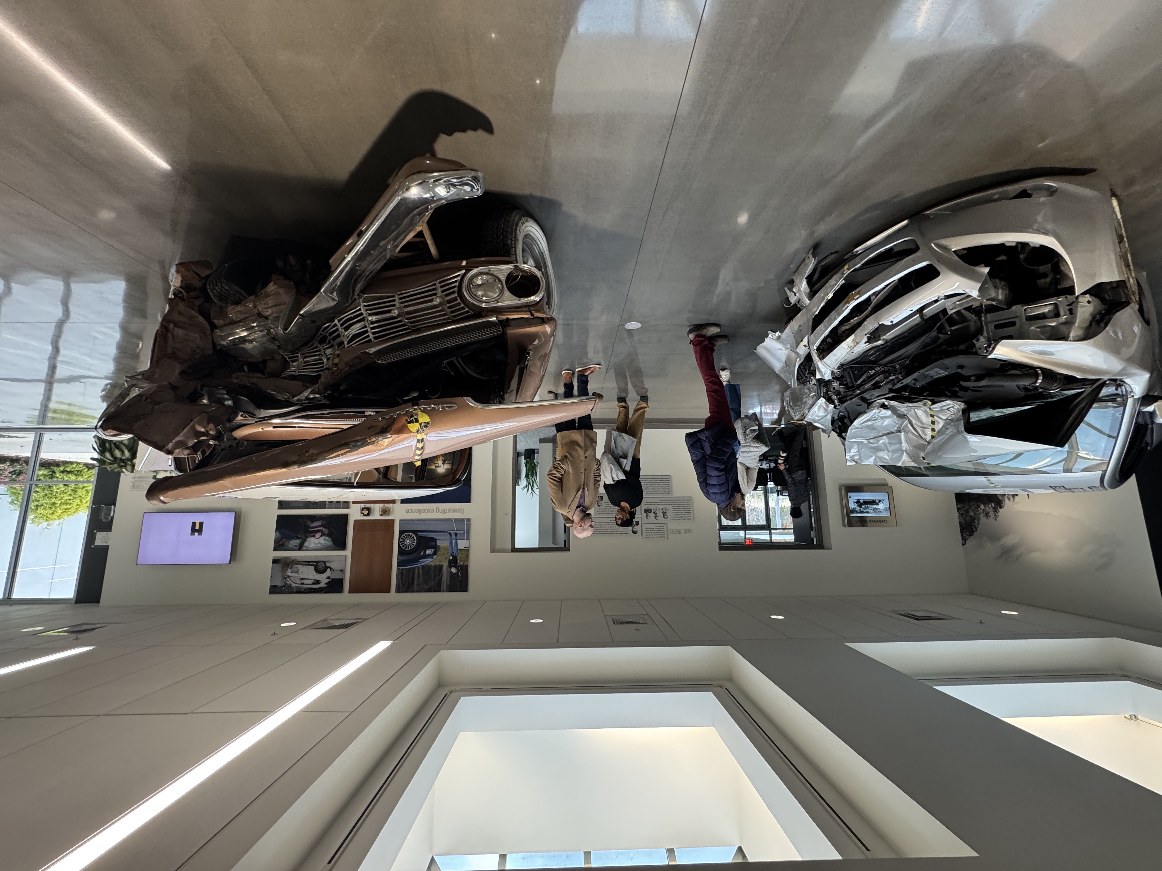 Two crash-tested cars in the IIHS lobby.