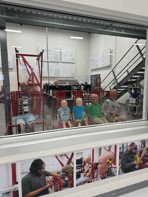 crash test dummies behind a window.