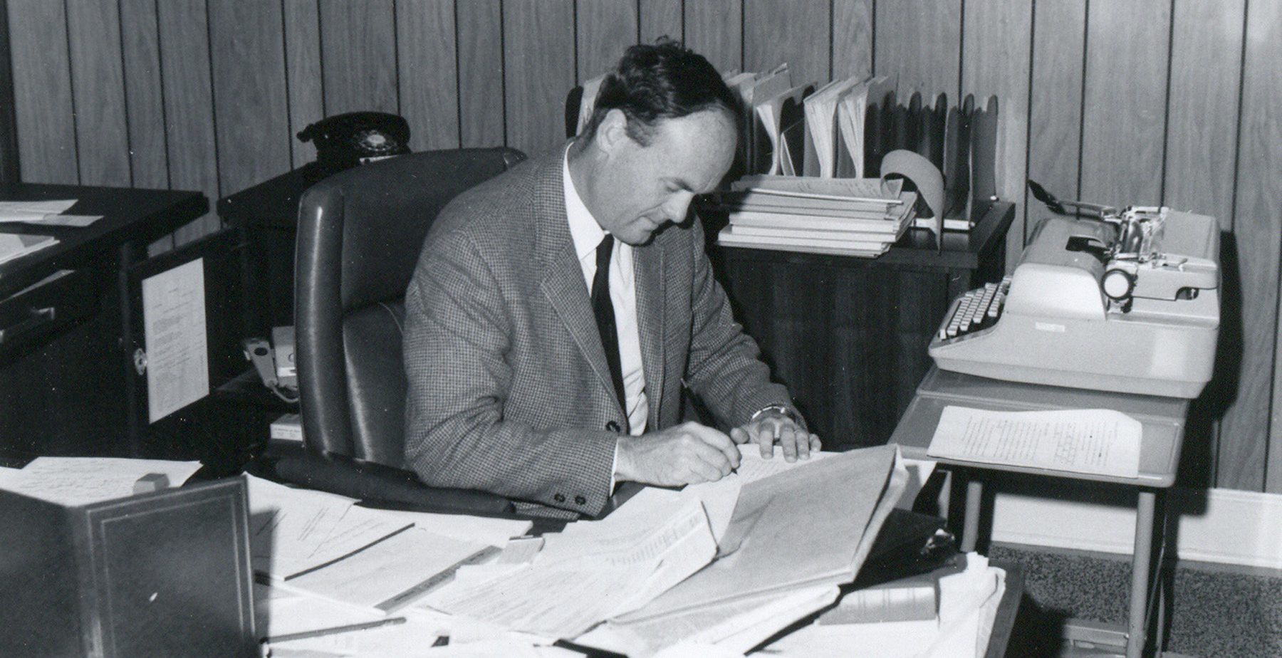 B.J. Campbell sits and works at his desk.